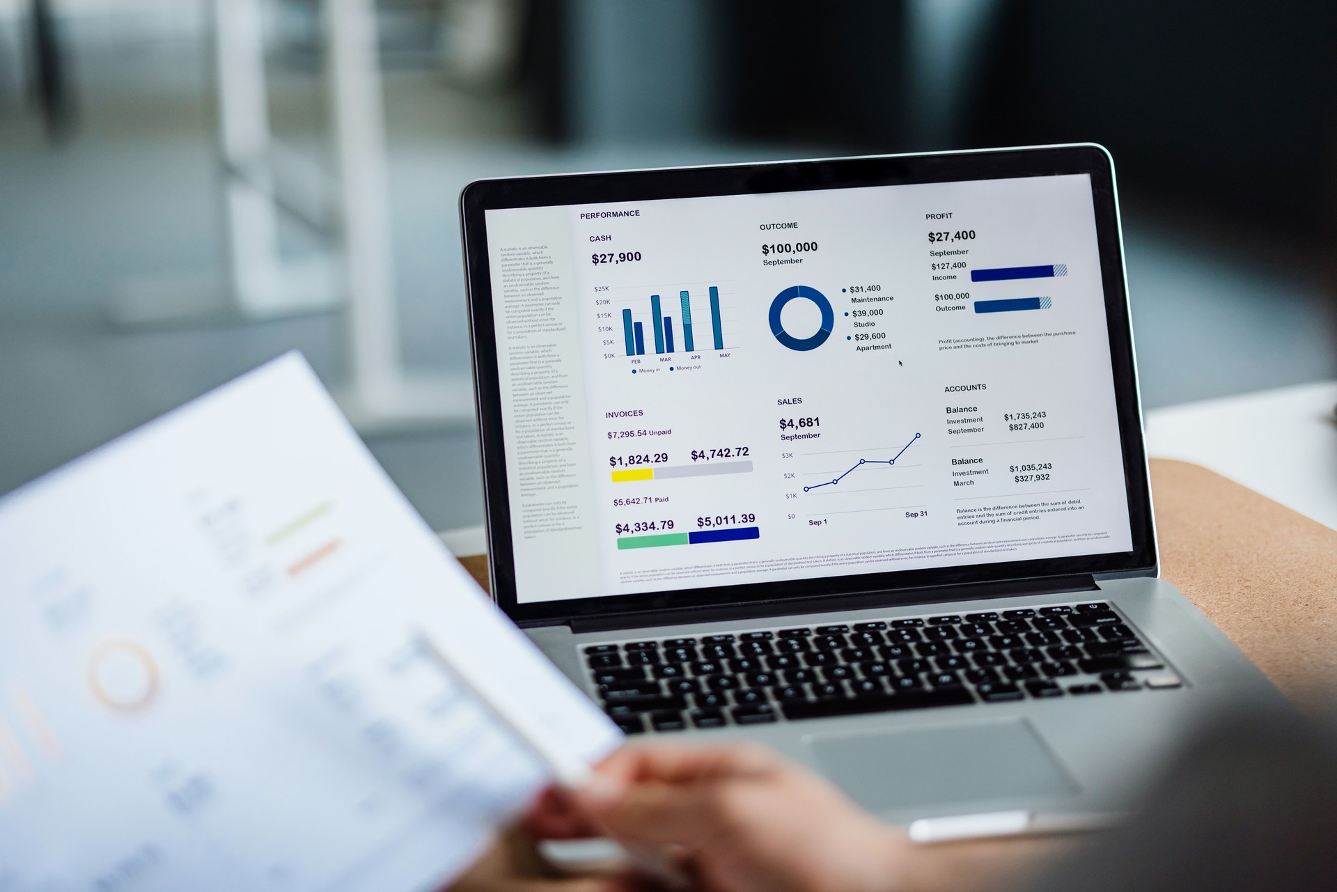 Close Up Photo Of Man Hands Analyzing Business Graph On A Paper And Laptop Computer In The Office